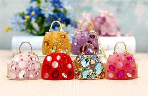 Detail of 6 mini handbag keychains with rhinestones and gems in varied colors