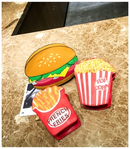 Detail view of burger and fries crossbody bags with PU leather textures and chains