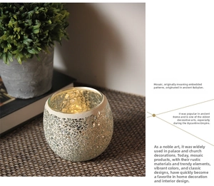 Detailed close-up of mosaic glass candle holder with metallic rim on woven mat