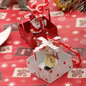 Hanging Christmas ornaments featuring Santa Claus and Snowman in festive gift box shapes