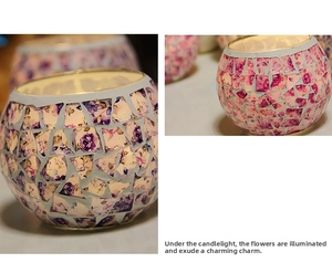 Close-up of European mosaic glass candle holder with purple and pink floral patterns