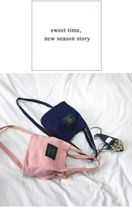 Detailed shot of canvas bucket bags in pink and navy with Living Traveling Share label