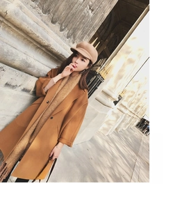 Detailed texture of camel mohair wool coat with matching scarf and newsboy cap in autumn