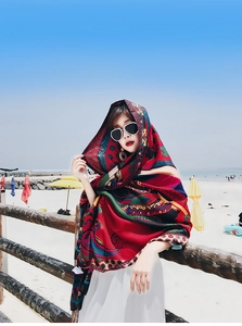 Ethnic style bohemian print beach shawl scarf worn by a model at the seaside