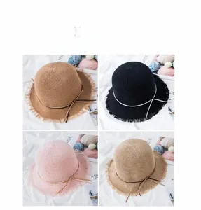 Close-up of woven straw hats in four colors with frayed edges and slim bow detail