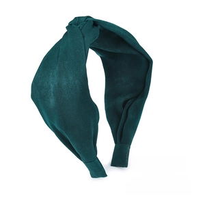 Detail shot of the dark green knotted headband showing high-quality matte suede fabric texture