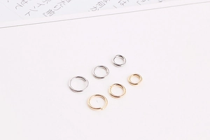Detailed view of gold and silver plated jump rings in three sizes for DIY jewelry making