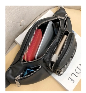 Top view of black leather waist bag showing open compartments and silver hardware