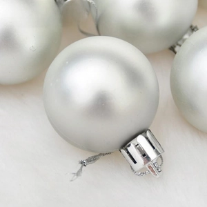 Macro view of a silver matte Christmas ball ornament with a festive silver hanging cap