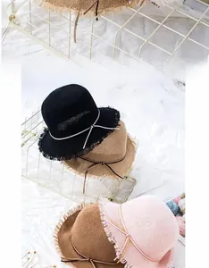 Close-up of foldable woven straw sun hats for kids with tassel brims in four colors