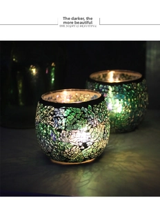 Close-up of European mosaic glass candle holders with glowing colorful glass patterns
