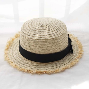 Detail of the natural beige boater straw hat with black satin ribbon and bow accent