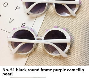 Detail of round white sunglasses featuring purple camellia flowers and pearl accents