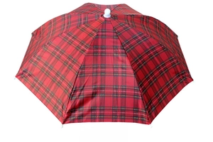 Detail view of the red plaid pattern and folding mechanism on this outdoor umbrella hat