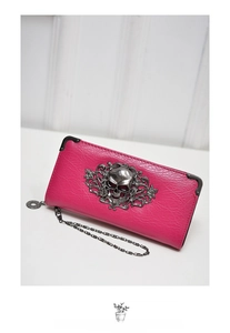 Detailed view of rose red skull wallet with floral relief and vintage silver chain strap