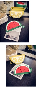 Detail view of watermelon and lemon shaped crossbody bags with creative zipper pulls