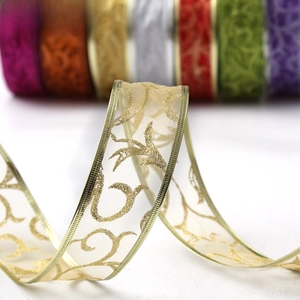 Macro detail of 200cm Christmas ribbon with silver glitter floral patterns and wired edges