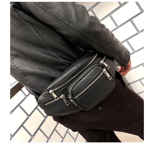 Side view of black PU leather waist bag with multi-zipper layers worn on black jacket