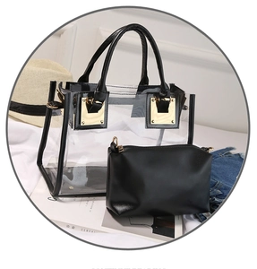 Detail of transparent PVC tote bag with black leather trim and gold metal hardware
