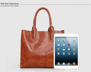Size comparison of a vintage brown leather tote bag next to an iPad showing large capacity