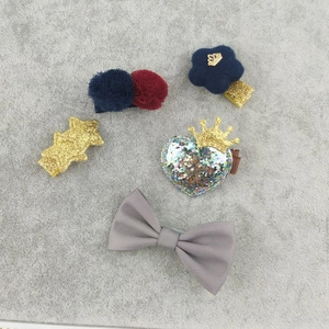 Detail of 5-piece girls hair clip set with mink fur crown, star, and heart patterns