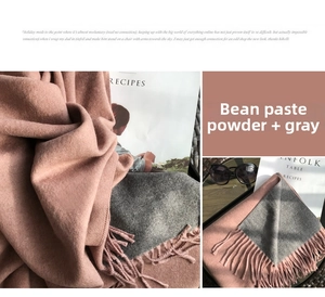 Close-up of thick tassels and soft texture on pink and gray double-sided scarf