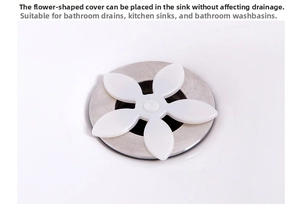 Close-up of white flower-shaped silicone sink strainer on a stainless steel drain