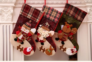 Detailed view of three hanging Christmas stockings with snowman and Santa decorations