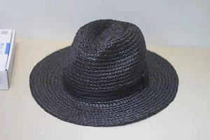 Detail of the woven texture and black ribbon band on this raffia fedora sun hat