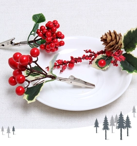 Close-up of Christmas clips with red berries, pine cones and green leaves for DIY decor