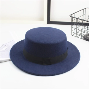 Close-up of dark blue wool felt boater hat with a classic black ribbon decorative band