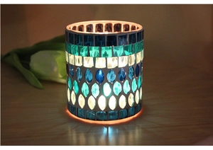 Detailed view of mosaic glass candle holder with blue and turquoise tile patterns