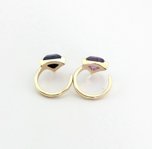 Detailed view of adjustable gold-finish rings with amethyst and lapis lazuli stones