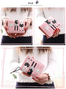Pink bifold women wallet with cute cat embroidery held by model in soft lighting