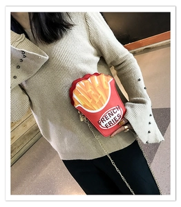 French fries shaped crossbody bag with chain strap shown on model for size perspective
