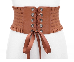 Women's wide brown lace-up corset belt with ribbon bow, elastic waist cincher accessory.