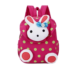 Detail of a pink polka dot canvas backpack with a 3D plush bunny doll for toddlers