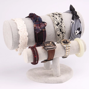 Detail of grey velvet double-tier cylindrical display rack for watches and bracelets