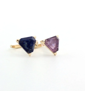 Macro detail of gold-plated open ring with triangle amethyst and lapis lazuli stones