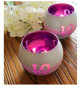 Detail of grey and pink mosaic glass candle holder with LOVE and heart cutouts