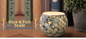 Close-up of blue fish scale mosaic glass candle holder with artistic handcrafted texture