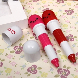 Close-up of pink and red capsule-shaped pill pens with Vitamin Ballpen text detail