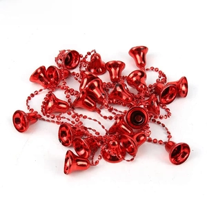 Detail of red beaded Christmas bell garland for festive tree and door wall decoration
