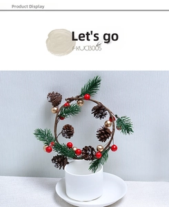 Mini Christmas wreath with pine cones and red berries displayed in a white cup