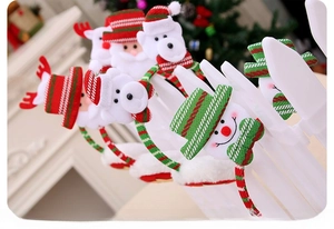 Detail showing plush Christmas headbands with Reindeer and Santa motifs on a display rack