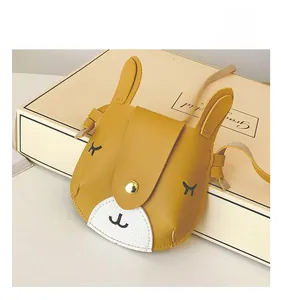 Close-up of yellow bunny-shaped kids crossbody bag with embroidered eyelash details