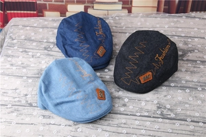Detail showing vintage denim newsboy caps in three colors with leather 1987 patches