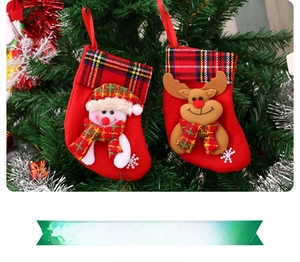 Detail of red Christmas stockings featuring 3D reindeer and snowman on a tree branch