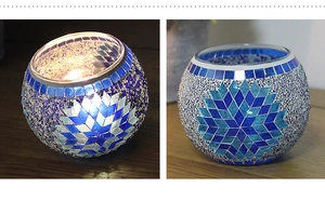 Dual view of blue mosaic glass candle holder showing lit glow and detailed silver pattern