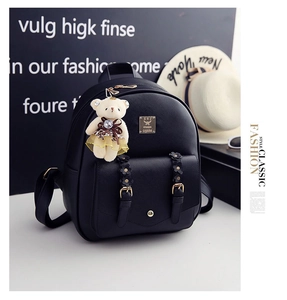 Detailansicht schwarzer Kunstleder-Rucksack mit Blumenschnallen und Teddybär-Anhänger